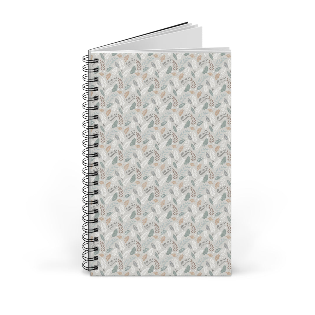A spiral-bound notebook with a light gray cover featuring a repeating botanical pattern in muted sage green, beige, and taupe, shown on a clean white background.