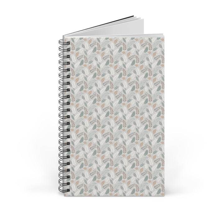 A spiral-bound notebook with a light gray cover featuring a repeating botanical pattern in muted sage green, beige, and taupe, shown on a clean white background.