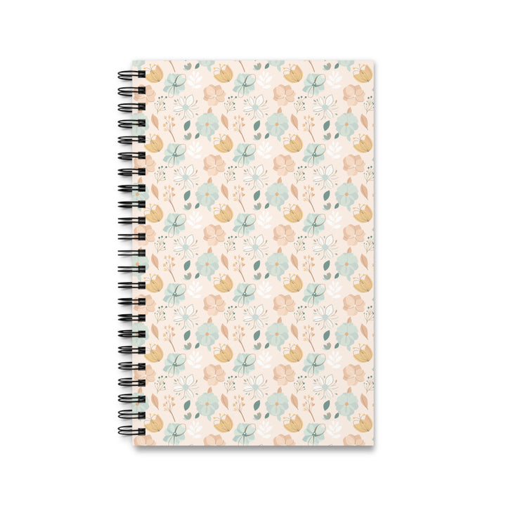 A spiral-bound notebook with a pastel floral pattern on a cream cover, shown against a plain white background.