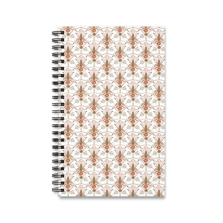 A spiral-bound notebook with a white cover featuring a repeating ornate damask pattern in muted terracotta and taupe, bound with a black metal spiral on a white background.