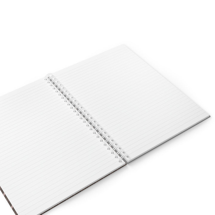 An open spiral-bound lined notebook with white pages, photographed at an angle on a clean white background.