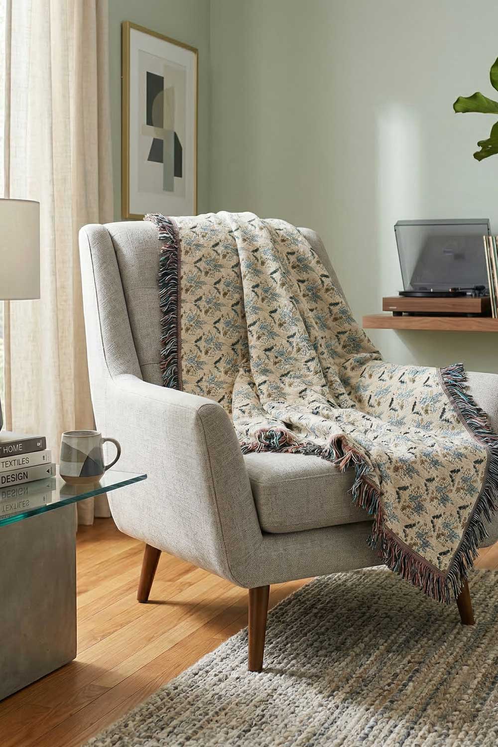 Decorative blanket draped over a chair in a living room setting