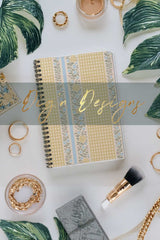 Decorative notebook with gold and green design elements on a white background
