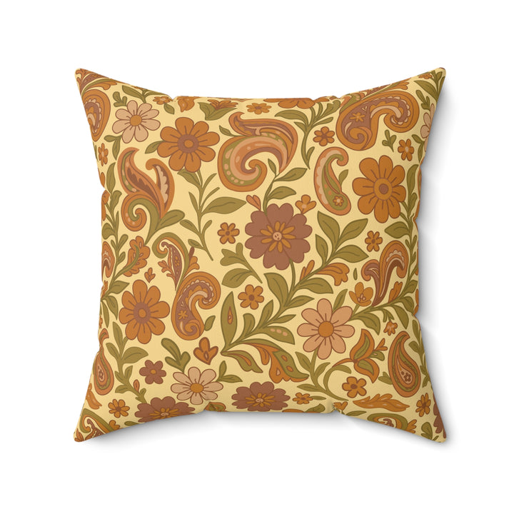 Decorative pillow with floral and paisley pattern on a beige background