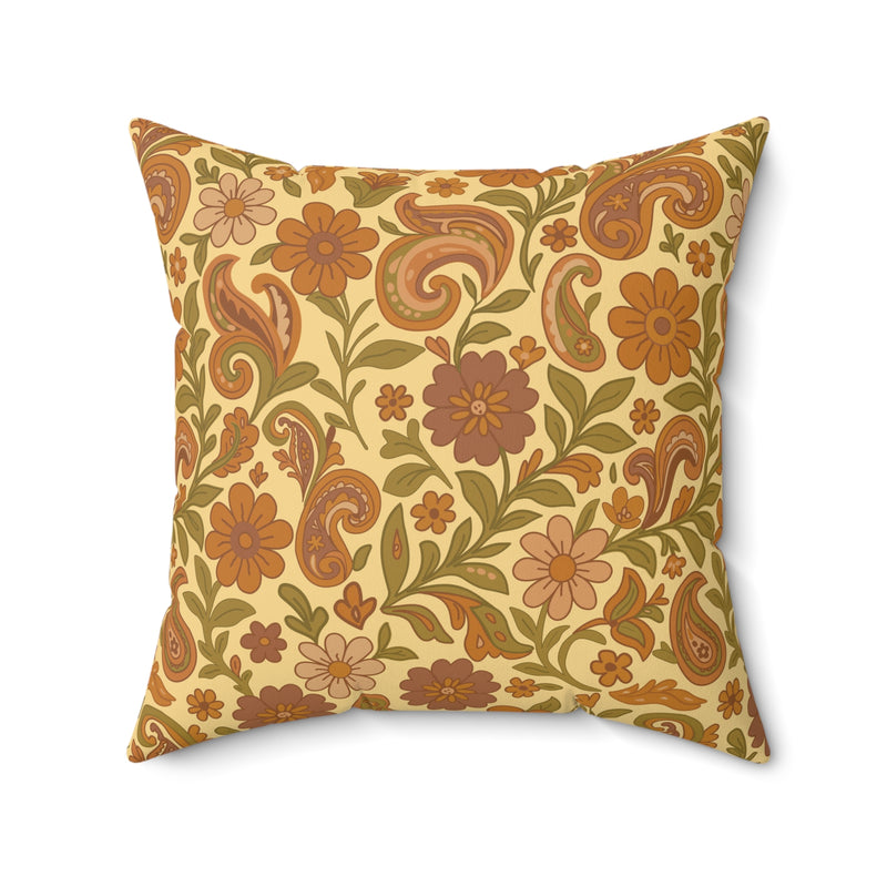 Decorative pillow with floral and paisley pattern on a beige background