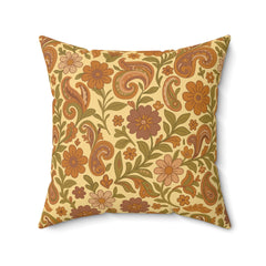 Decorative pillow with floral and paisley pattern on a beige background