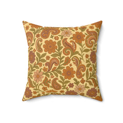 Decorative pillow with floral and paisley pattern on a beige background