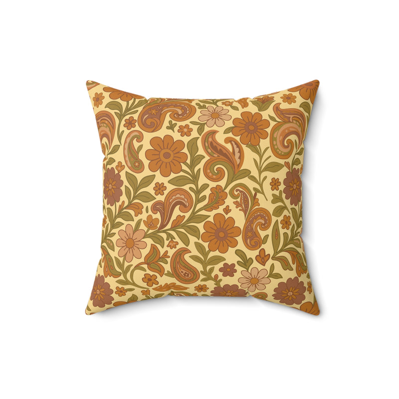 Decorative pillow with floral and paisley pattern on a beige background
