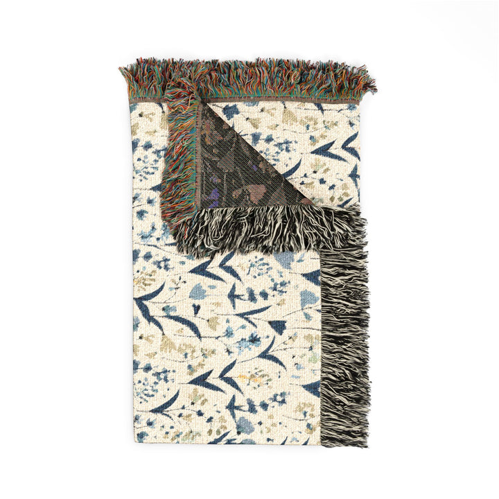 Decorative rug with a patterned design and fringed edge on a white background