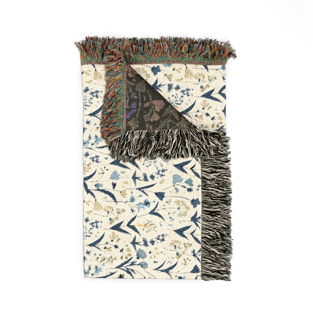 Decorative rug with floral pattern and fringe on a white background