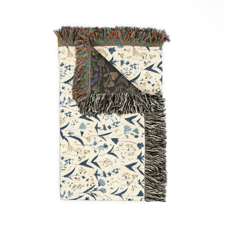 Decorative rug with floral pattern and fringe on a white background