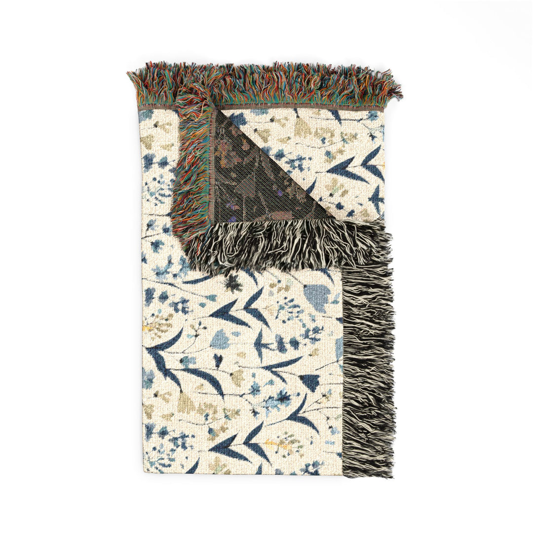 Decorative rug with floral pattern and fringed edge on a white background