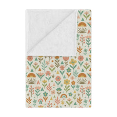 Floral and geometric patterned blanket with white backing