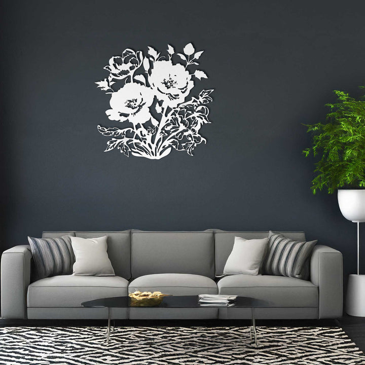 Gray sofa with decorative pillows against a dark wall with a floral design.