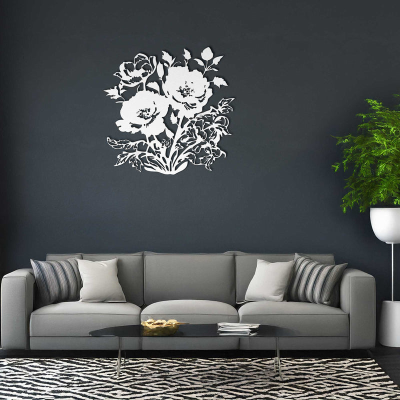 Gray sofa with decorative pillows against a dark wall with a floral design.