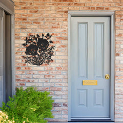 Light blue front door with decorative metal wall art on a brick wall