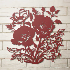 Red floral metal wall art on a white brick wall