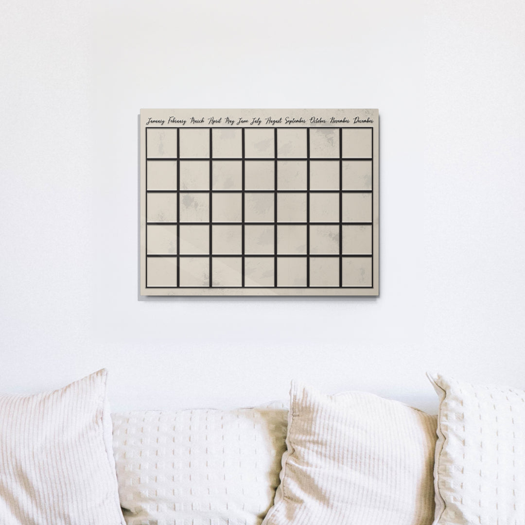 Dry erase reusable metal wall calendar on couch wall