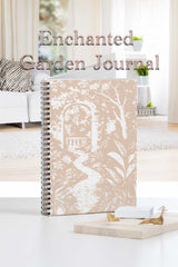 Enchanted Garden Journal with garden-themed cover in a home setting
