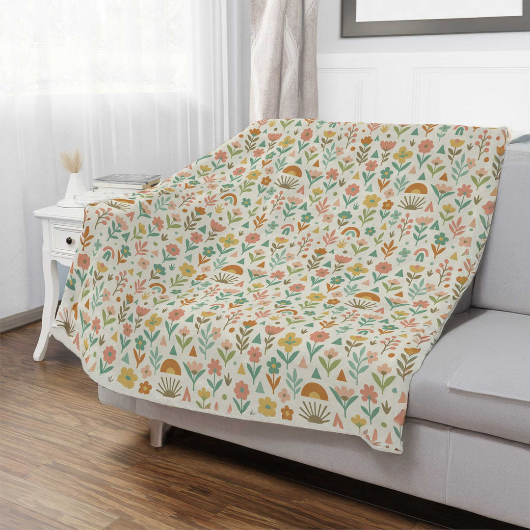 Floral patterned blanket draped over a sofa in a living room.
