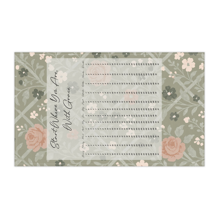 Floral-patterned tea towel with text on a white background
