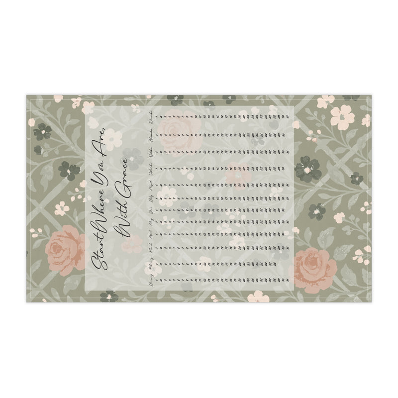 Floral-patterned tea towel with text on a white background