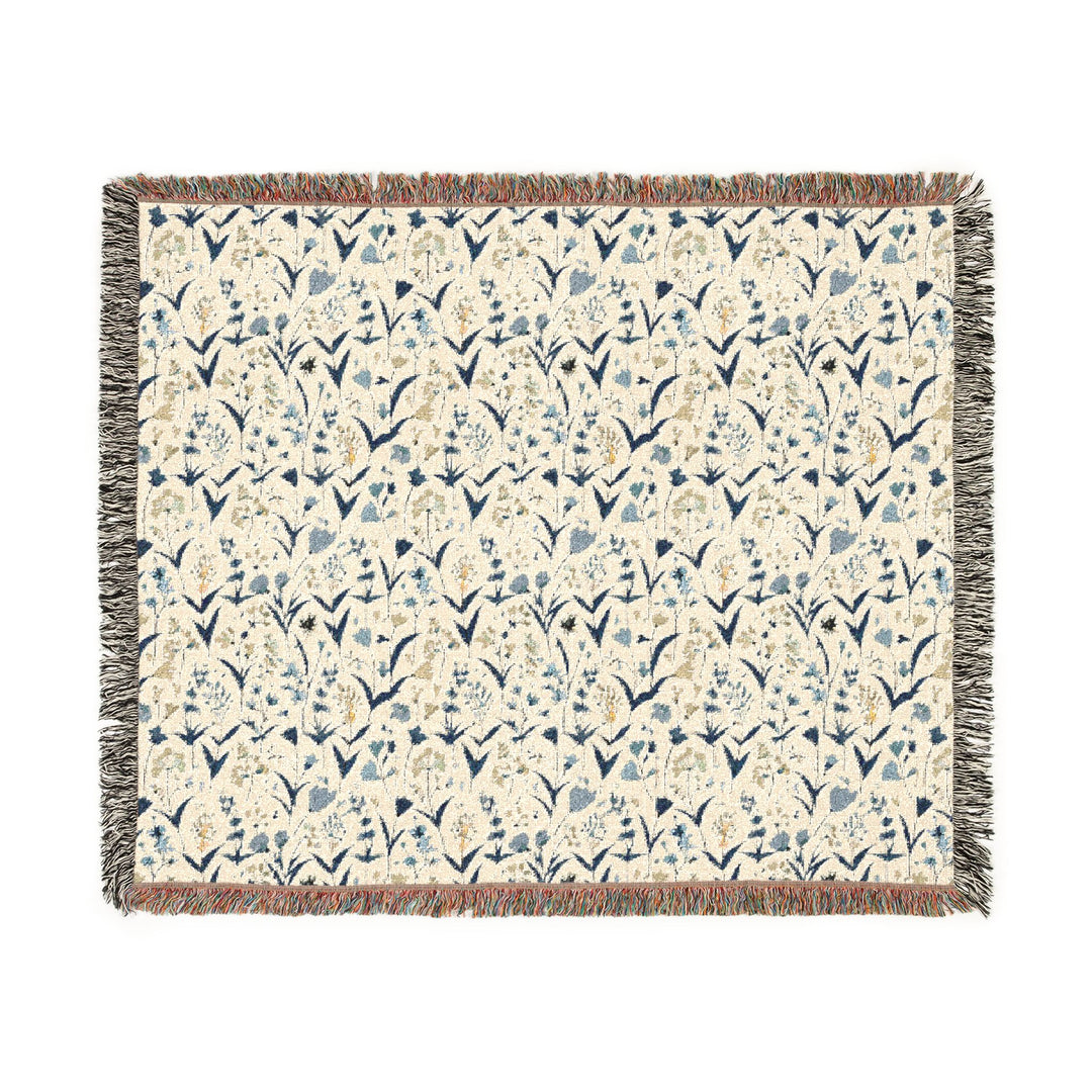 Floral patterned throw blanket with fringe on a white background