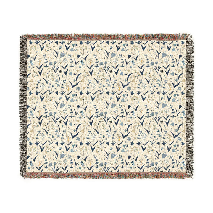 Floral patterned throw blanket with fringe on a white background