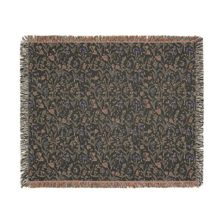 Floral patterned throw blanket with fringe on a white background
