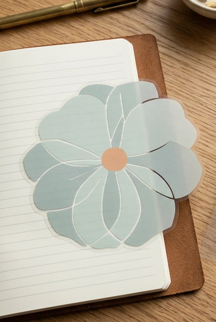 Floral sticker on a notebook with a pen in the background