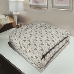 Folded blanket with butterfly pattern on a bed in a bedroom setting
