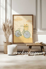 Framed artwork of a bicycle with a basket on a wall in a room with decor elements.