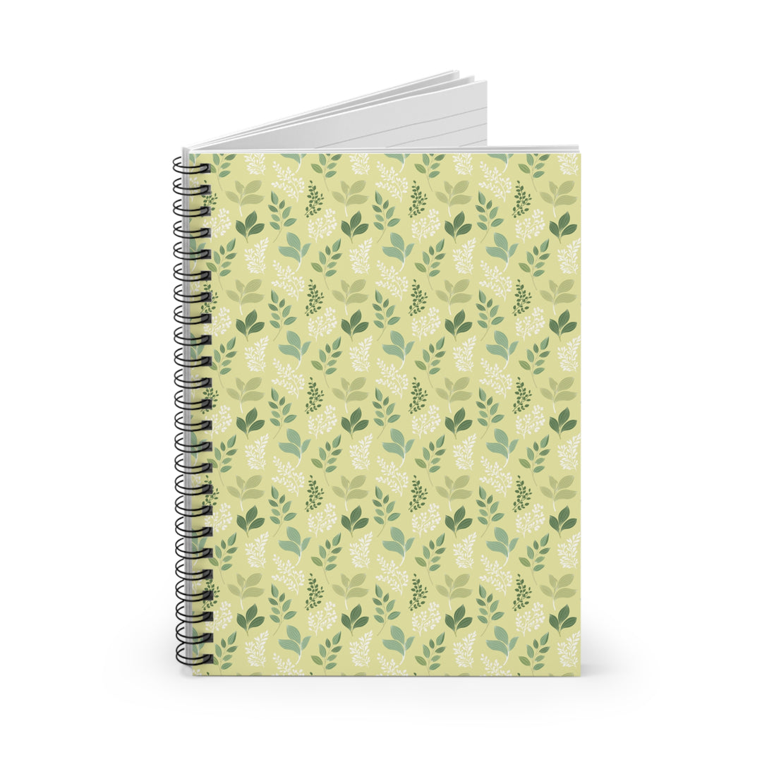 Notebook with a green leaf pattern on a beige backgrounda