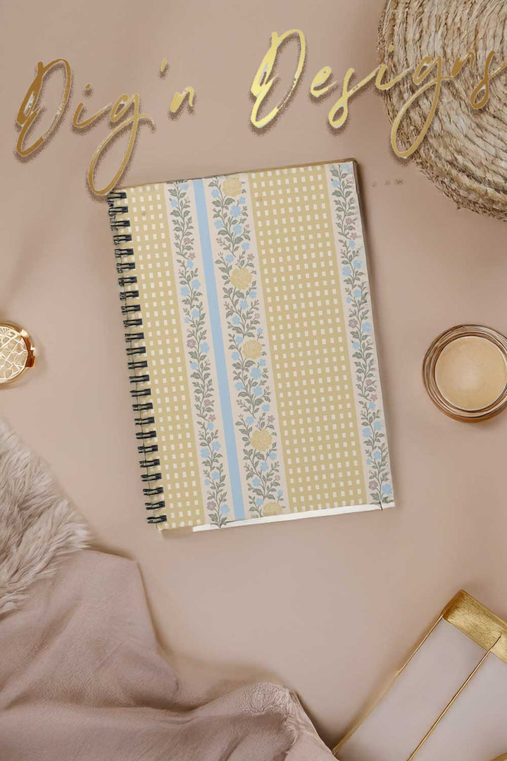 Notebook with decorative cover on a pink surface with &