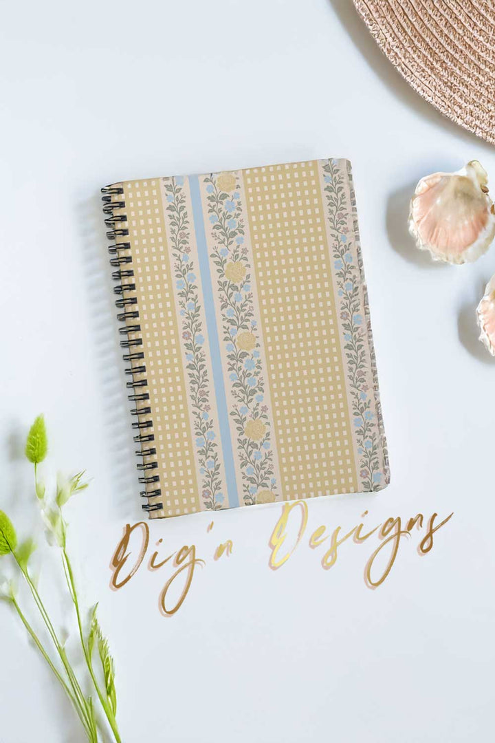 Notebook with decorative cover on a white surface with &