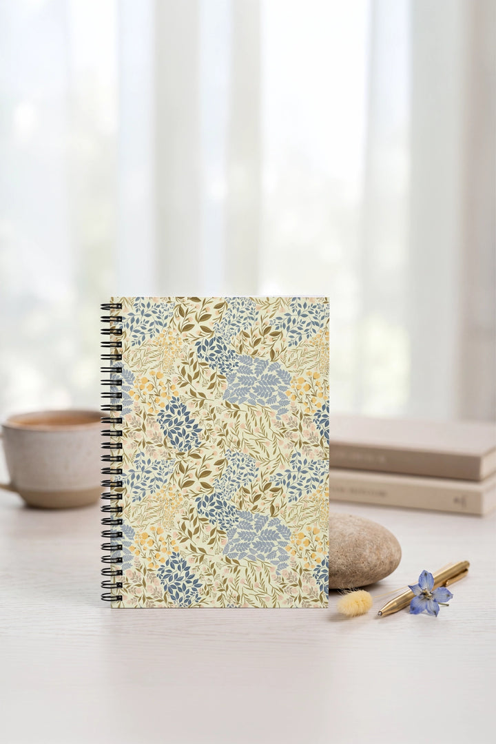 Notebook with floral pattern on a light surface with a blurred background