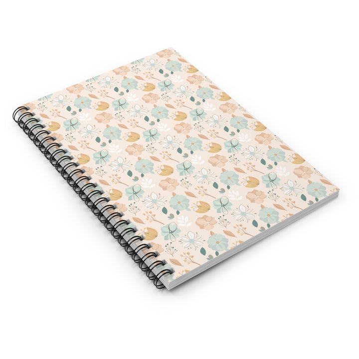 Spiral-bound notebook with a floral pattern on a white background