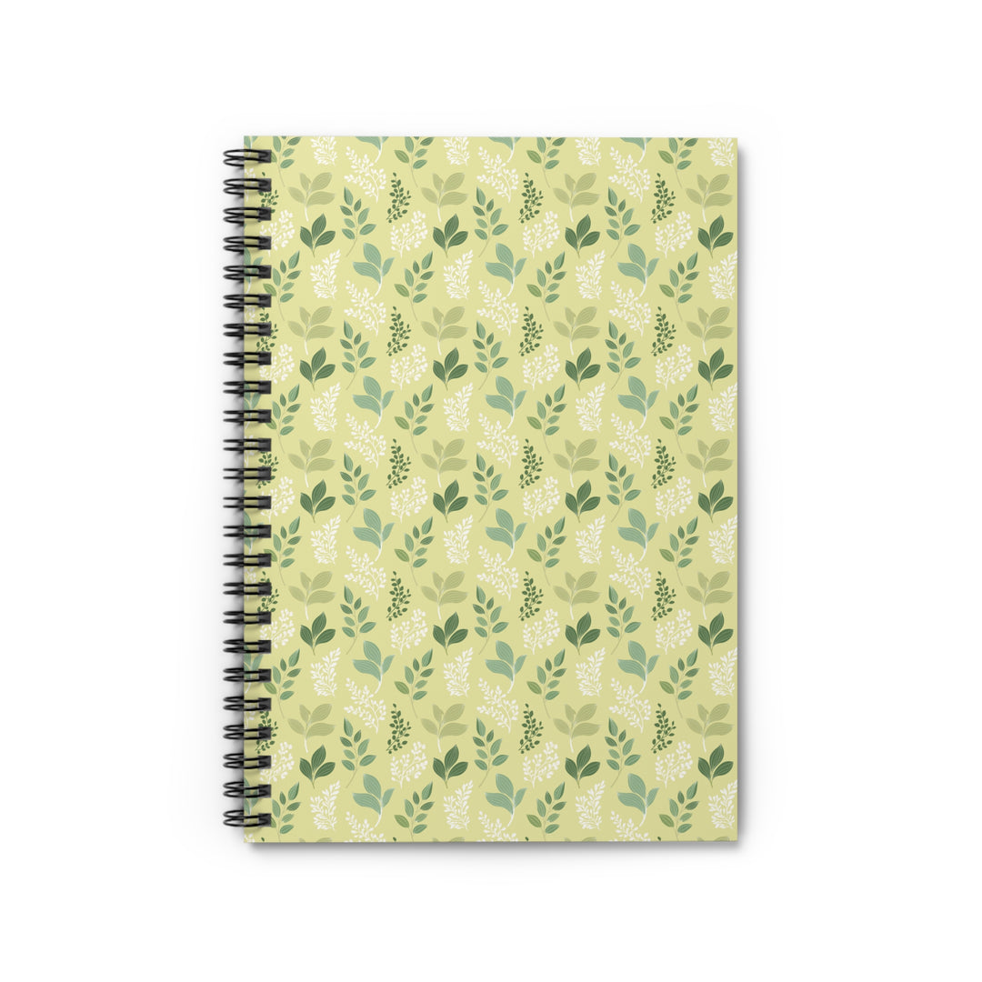 Notebook with green leaf pattern on a beige background