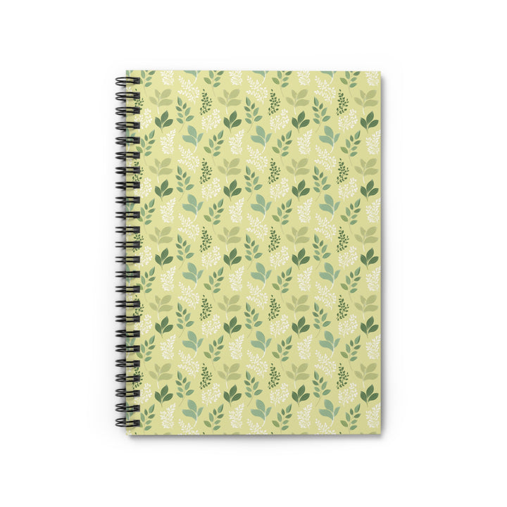 Notebook with green leaf pattern on a beige background