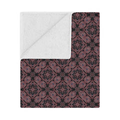 Patterned blanket with a white interior on a white background