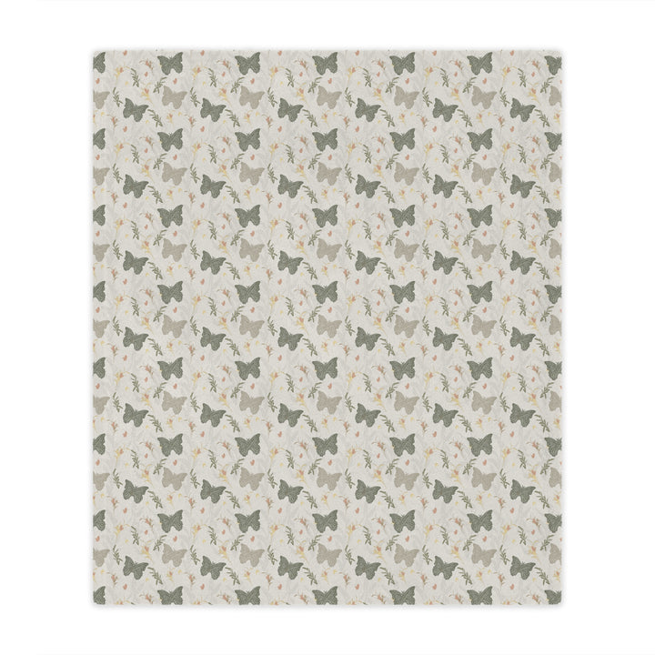 Patterned blanket with small butterfly illustrations on a light background
