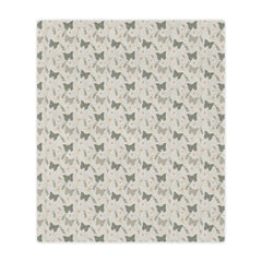 Patterned blanket with small butterfly illustrations on a light background