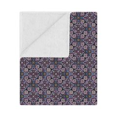 Patterned blanket with white reverse side on a white background
