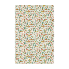 Patterned fabric with small floral and geometric designs on a light background