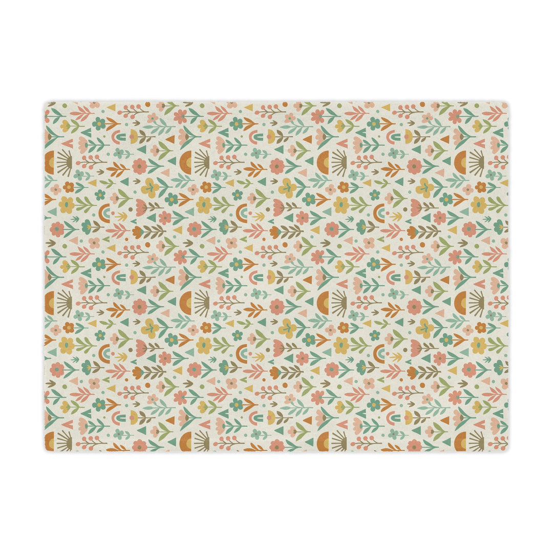 Patterned mat with floral and geometric design on a white background