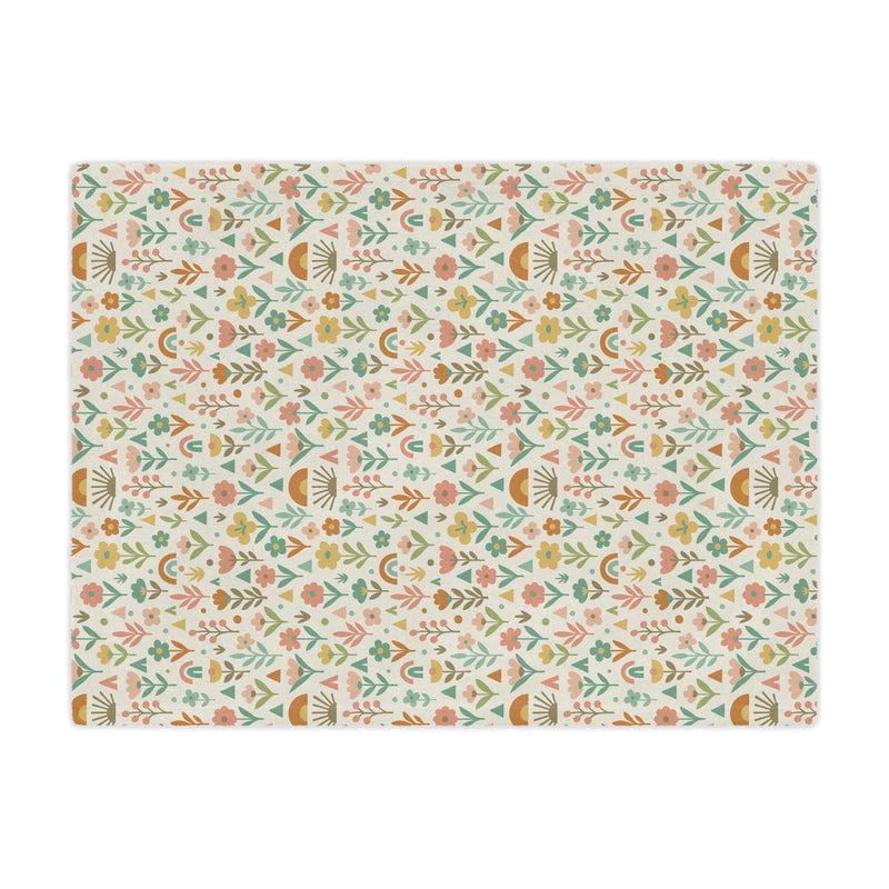 Patterned mat with floral and geometric design on a white background