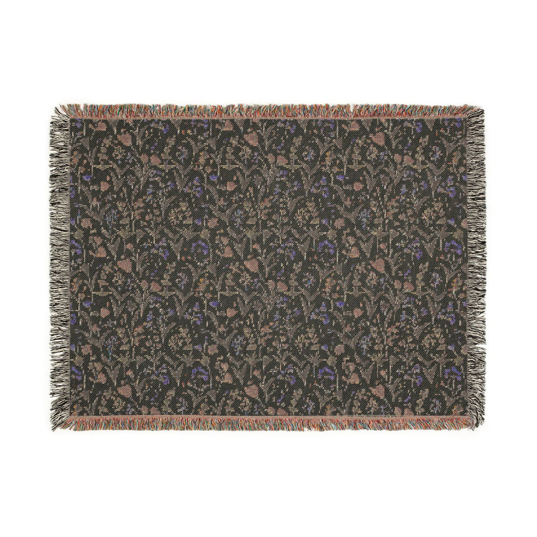 Patterned throw blanket with fringe on a white background
