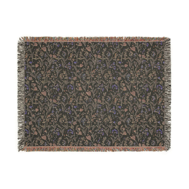 Patterned throw blanket with fringe on a white background