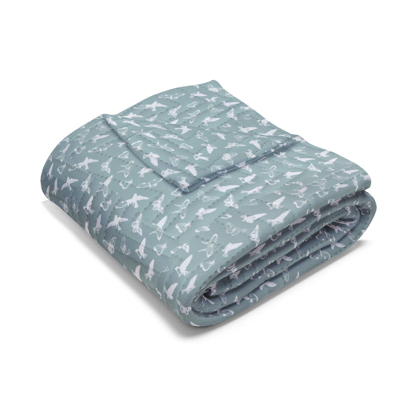 Quilted Throw Blanket – Serene Birds & Butterflies - White Silhouette on Teal folded