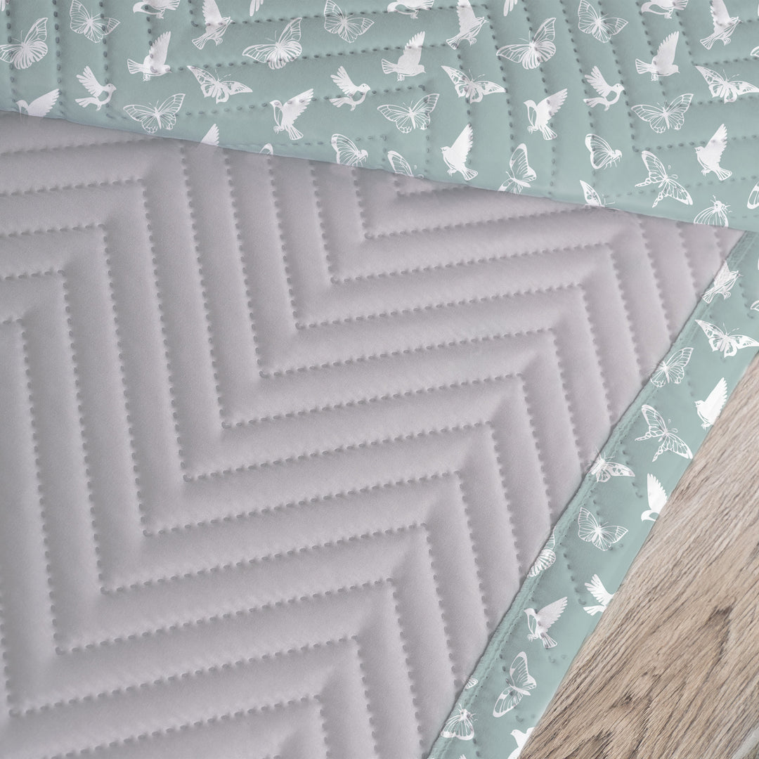 Quilted Throw Blanket – Serene Birds &amp; Butterflies - White Silhouette on Teal showing the back of the quilt